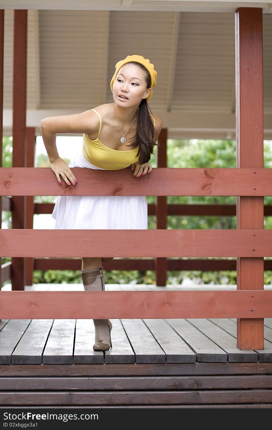 Girl standing on a veranda outdoor. Girl standing on a veranda outdoor