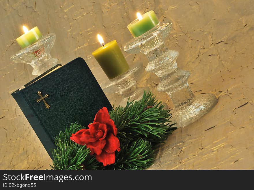 Green bible with pine branch and candles. Green bible with pine branch and candles