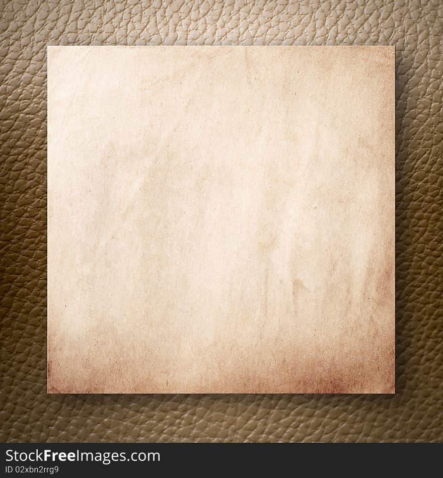 Old Paper On Light Brown Leatherette Background