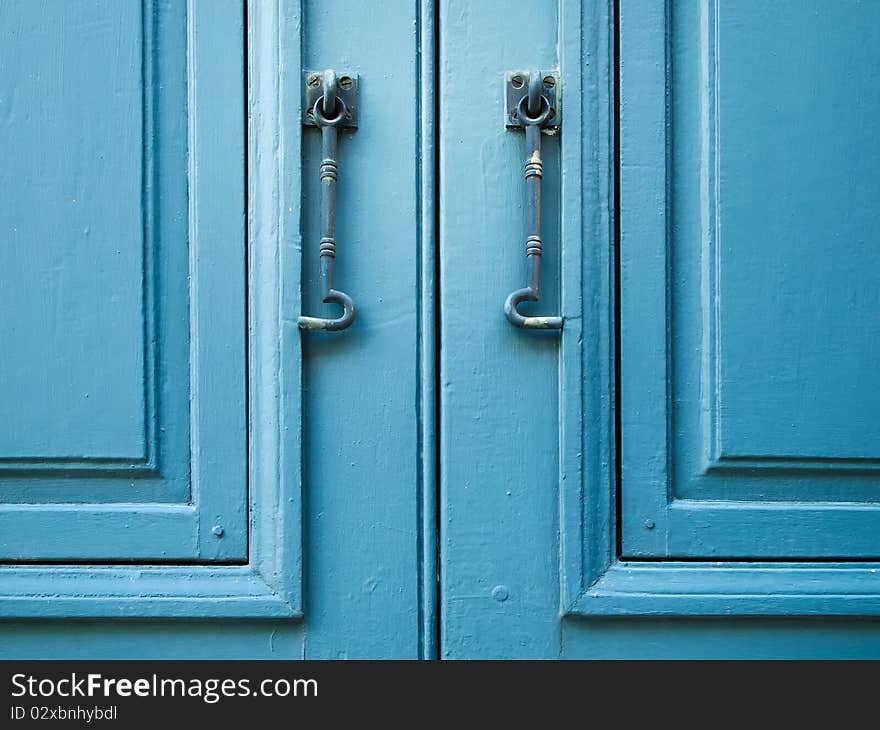 Pair of window hook on Blue wood window