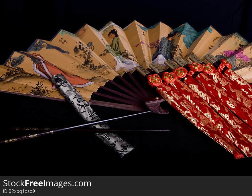 Arranged chinese chopsticks accompanied by a fan. Arranged chinese chopsticks accompanied by a fan