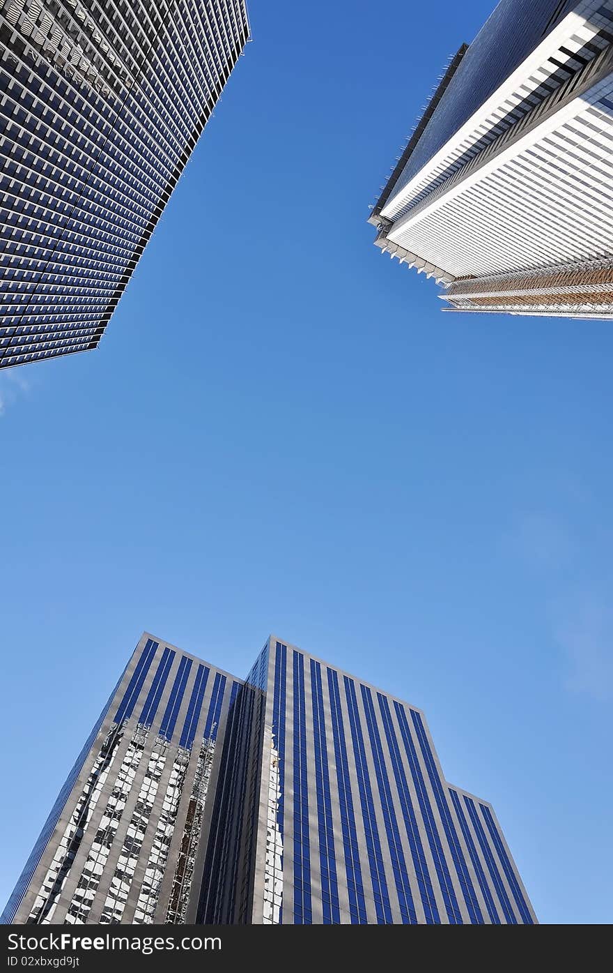 High modern skyscrapers on a background of the blue sky.  Downtown - business center of Toronto, Canada. High modern skyscrapers on a background of the blue sky.  Downtown - business center of Toronto, Canada