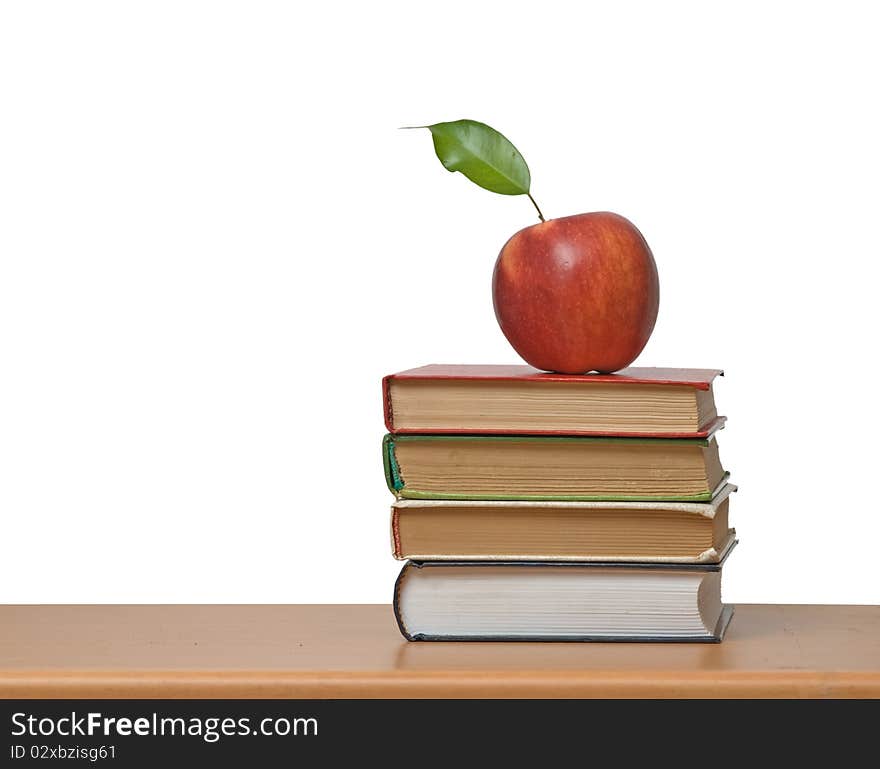 Red apple and books on desk