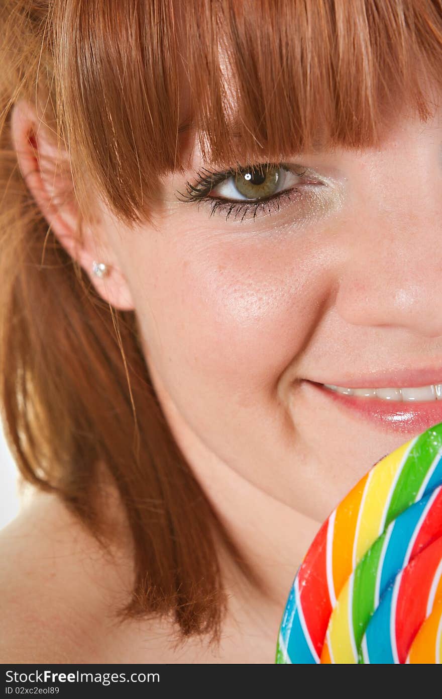 Red haired woman to lolipop - closeup. Red haired woman to lolipop - closeup.