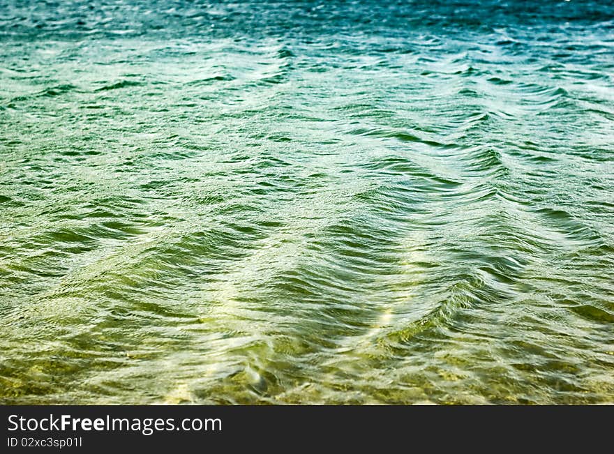 Small ripples on the water. Water color similar to the gradient from green to blue