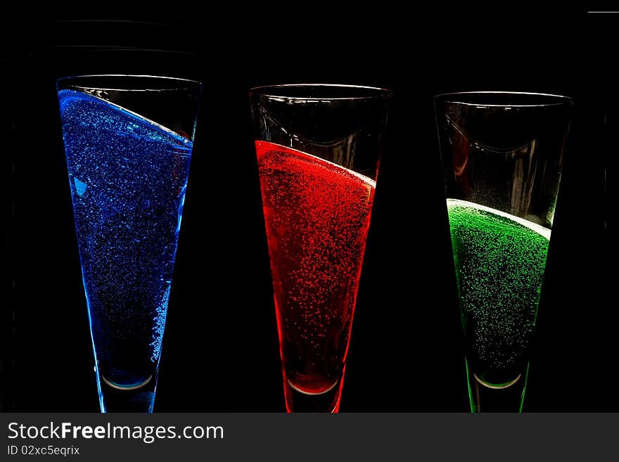 Champagne glasses filled with coloured sparkly win