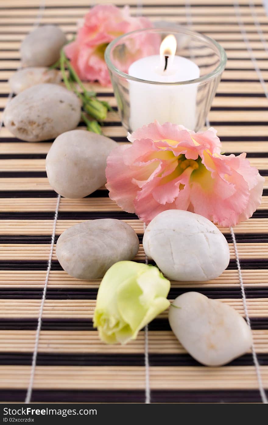 Stones With Candle On Bamboo Mate