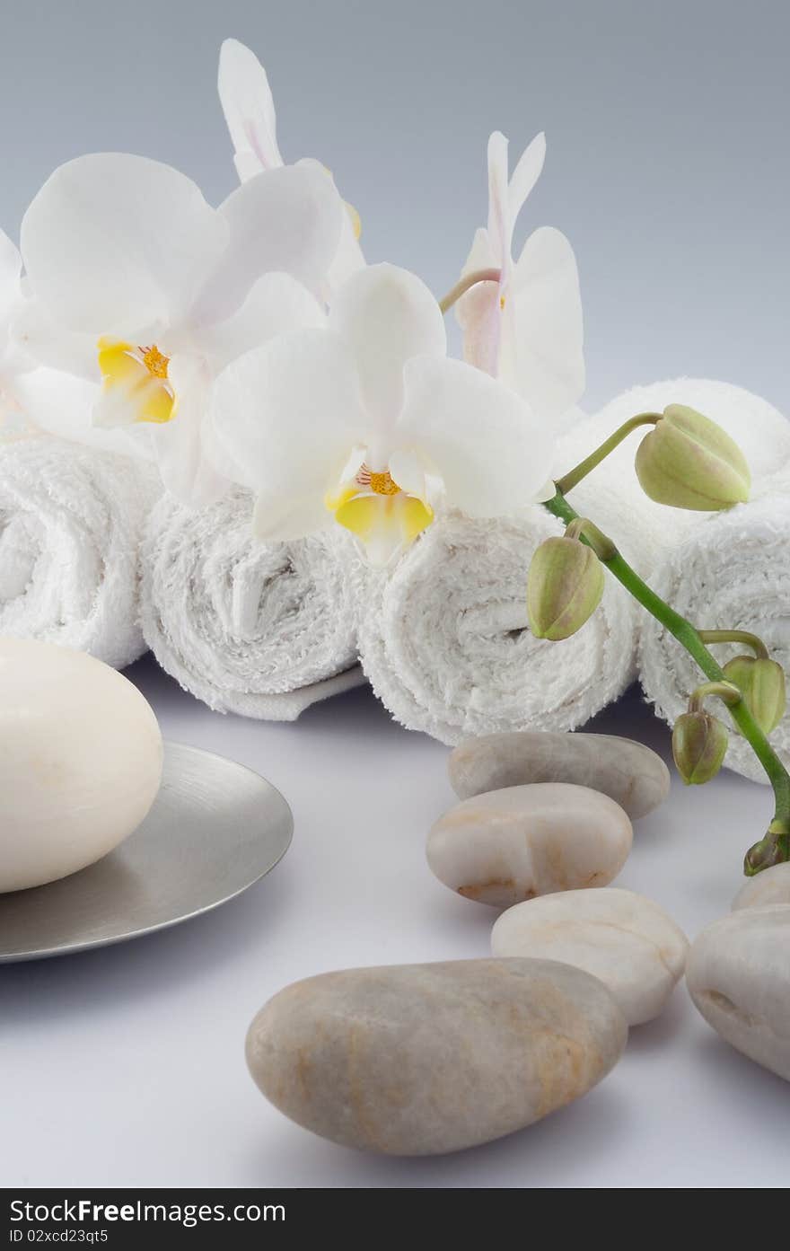 White towels and soap, orchid, on white bacground. White towels and soap, orchid, on white bacground