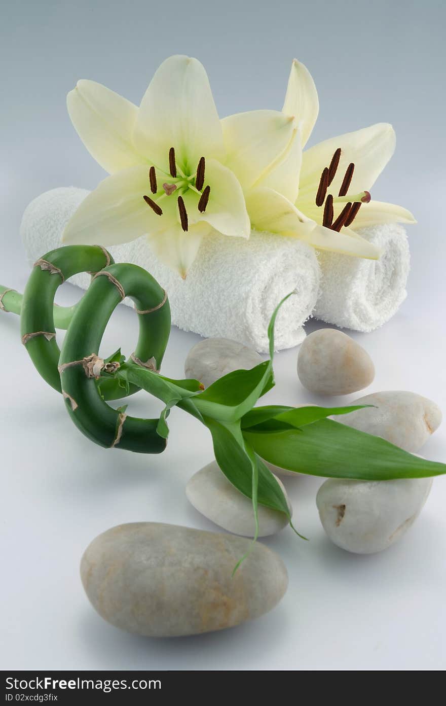 White towels and orchid, stones, bamboo on white bacground. White towels and orchid, stones, bamboo on white bacground