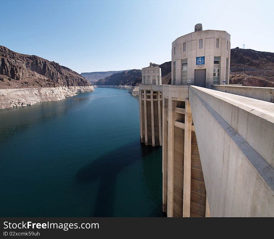 Hoover Dam's sculptured turrets, clock faces on the intake towers set for the time in Arizona. Hoover Dam's sculptured turrets, clock faces on the intake towers set for the time in Arizona.