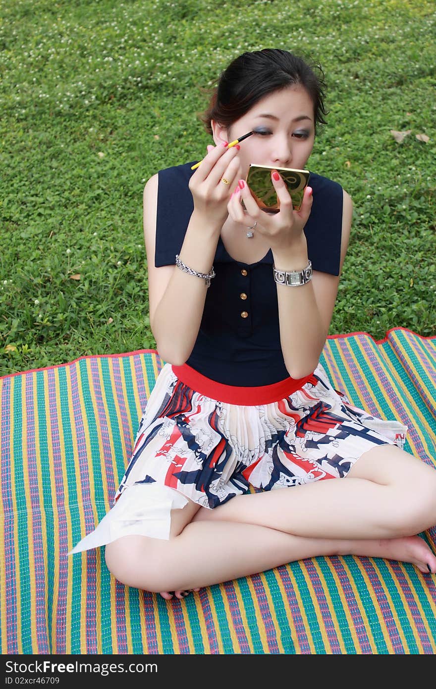 Beautiful woman applying colorful eye makeup. Beautiful woman applying colorful eye makeup