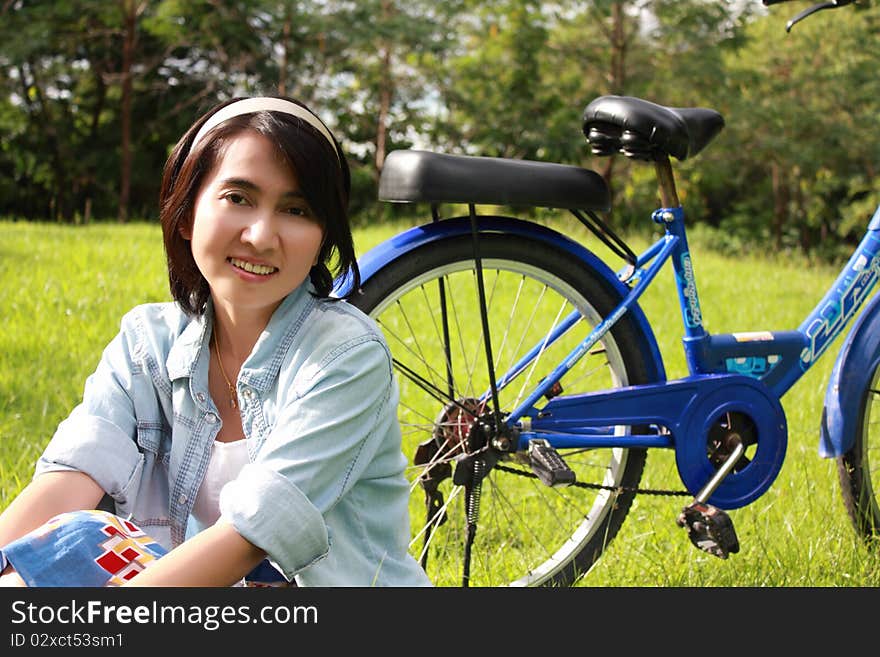 Woman with a bike outdoors smiling