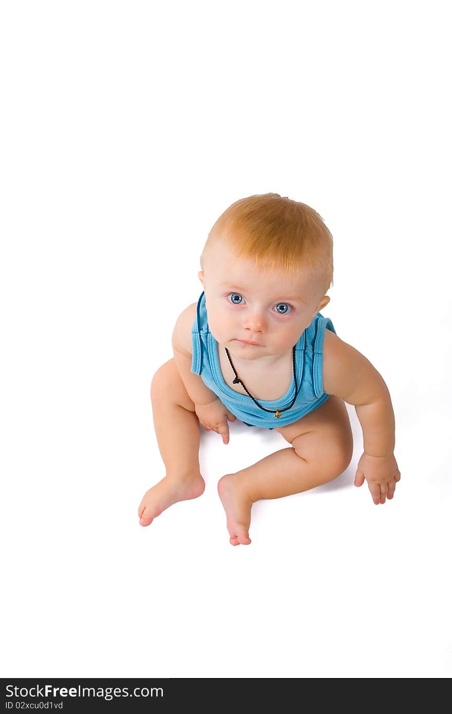 Little boy sitting on white background