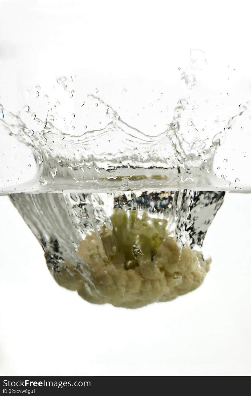 Falling cauliflower splashing into water.