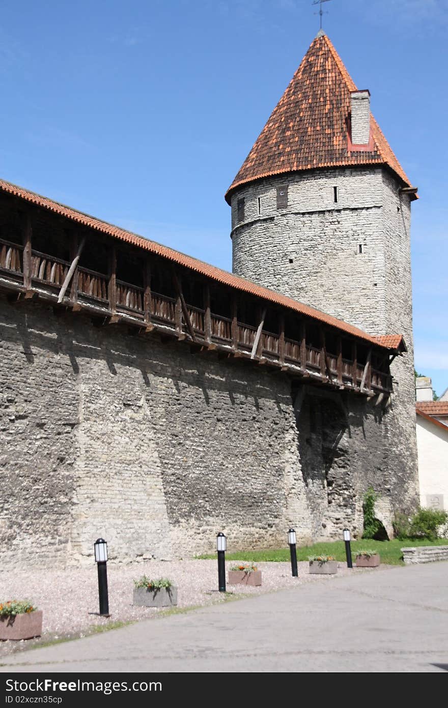 Part of the old city wall with one of the towers in Tallinn - the capital of Estonia. Part of the old city wall with one of the towers in Tallinn - the capital of Estonia