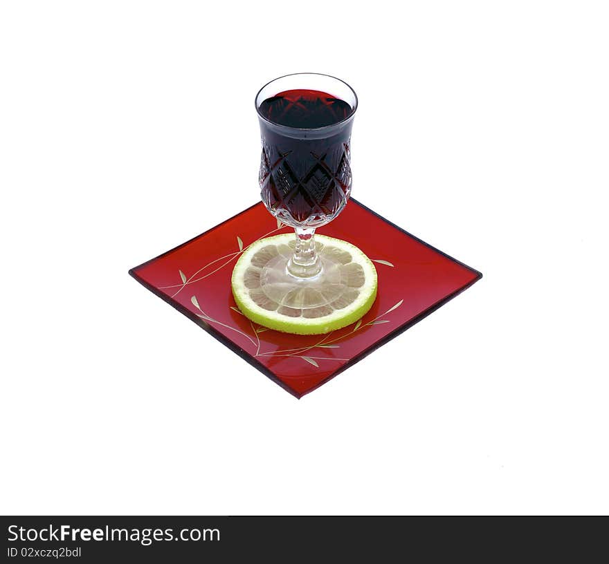 A wineglass of  red wine with one slice of lemon