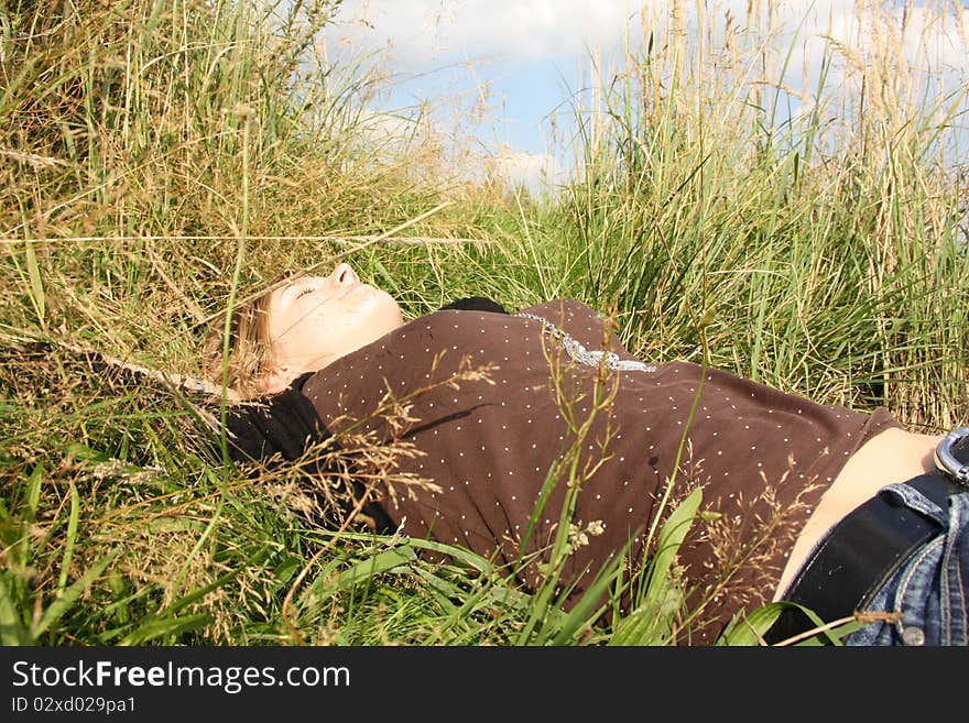 Young woman is in the grass