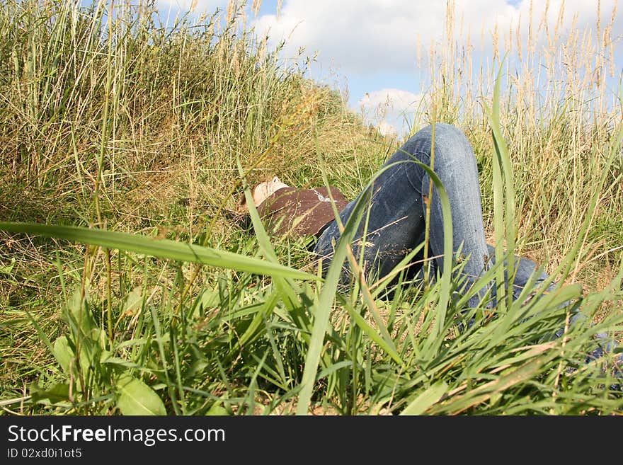 Young woman is relaxing in the grass