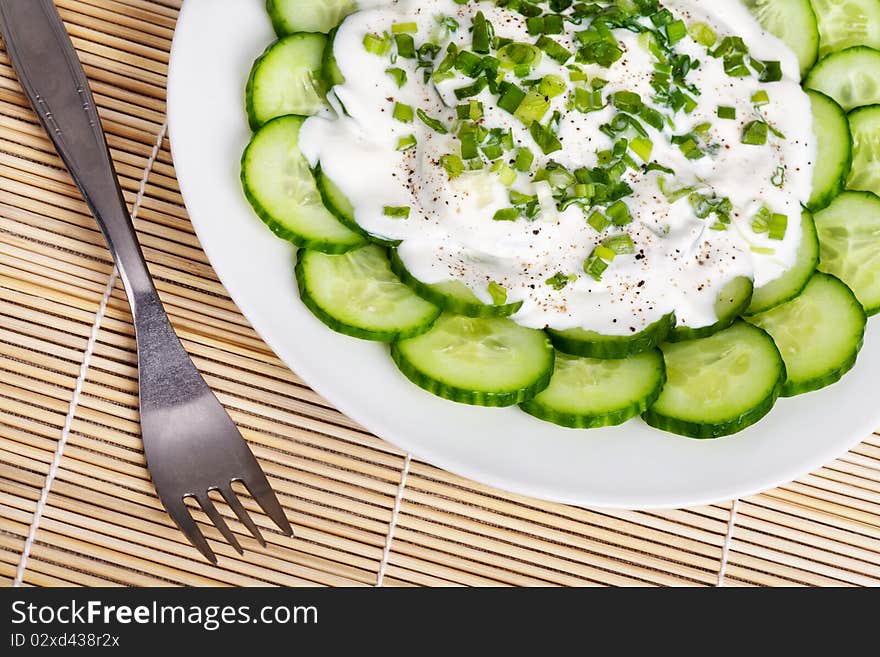 Fresh cucumber slices with sour cream