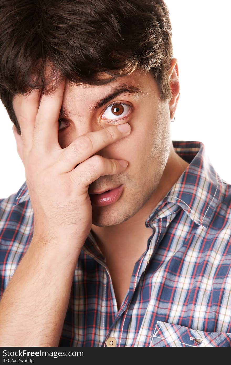 Portrait of young dark-haired grimacing man isolated on white background. Portrait of young dark-haired grimacing man isolated on white background