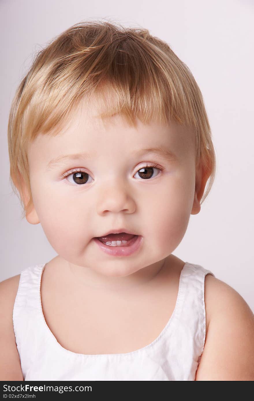 Portrait of smiling baby girl with attentive look, studio shot. Portrait of smiling baby girl with attentive look, studio shot