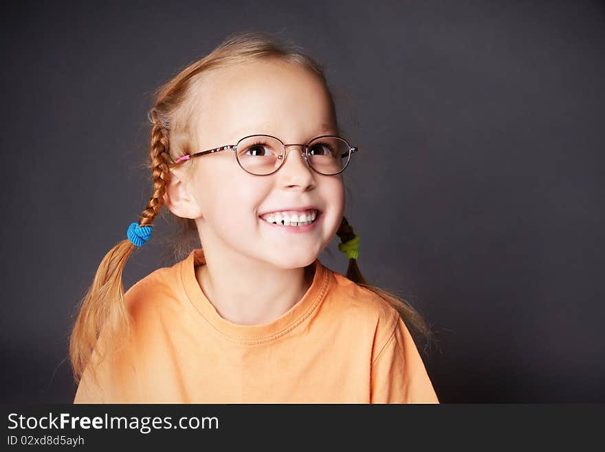 Portrait of happy joyful girl in glasses looking up, studio shot. Portrait of happy joyful girl in glasses looking up, studio shot