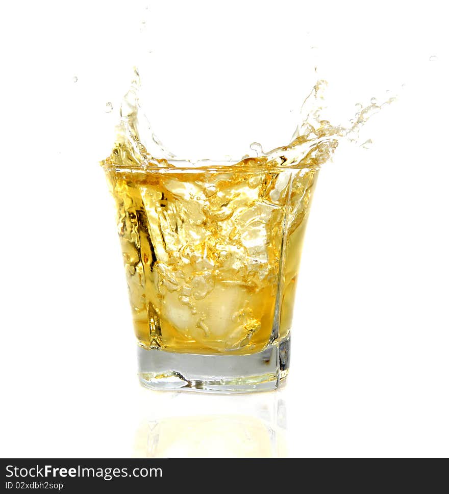 GLass with Whiskey splashing out, isolated on white background