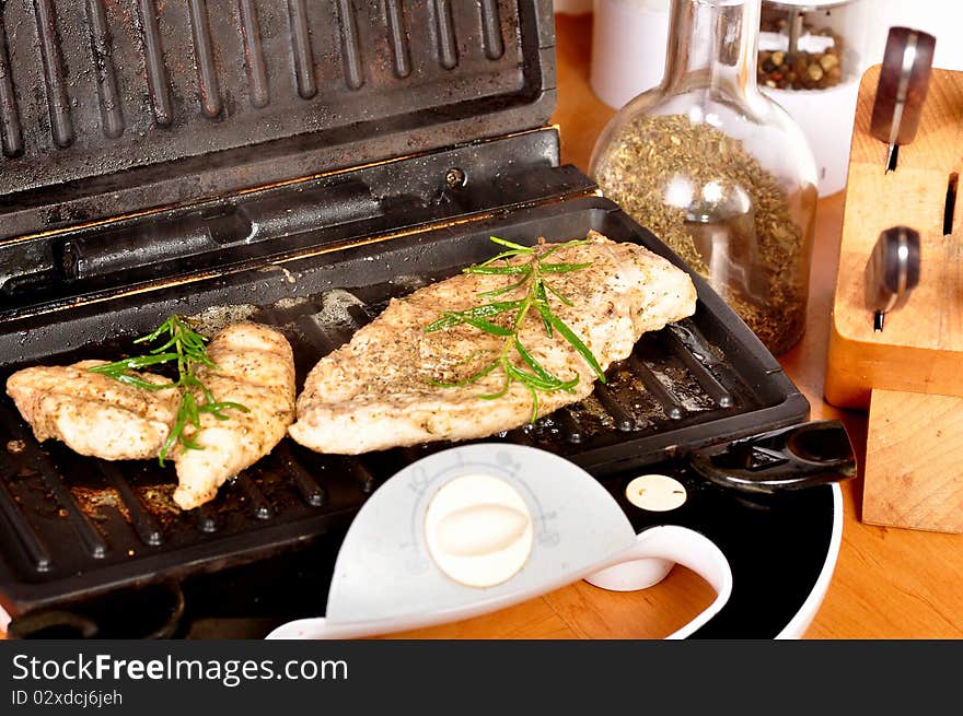 Making of chicken breast on electric grill. Making of chicken breast on electric grill.