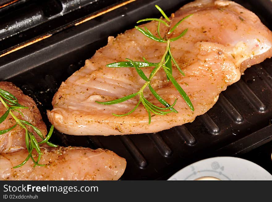 Making of chicken breast on electric grill. Making of chicken breast on electric grill.