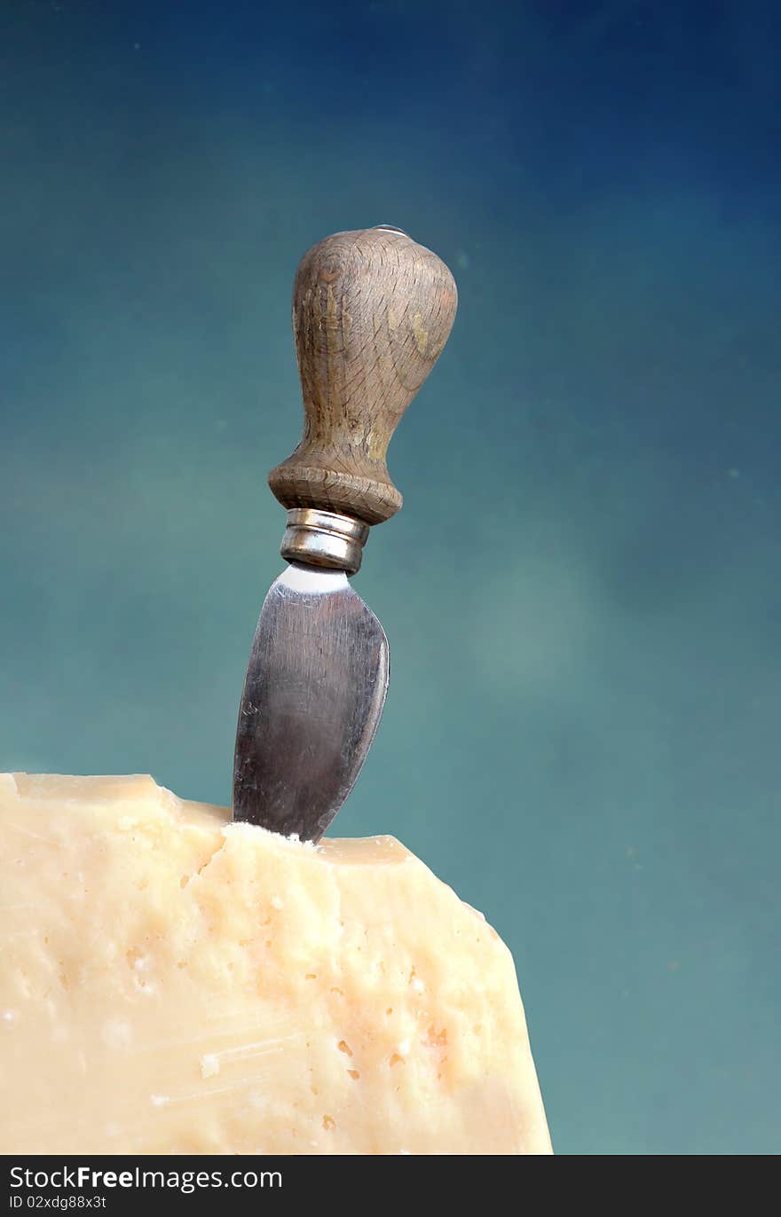 Cheese knife on a slice of parmesan