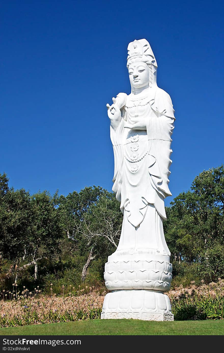 Statue of white stone standing buddha