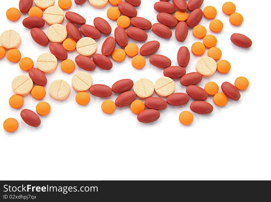 Orange red and pink pills isolated on white background