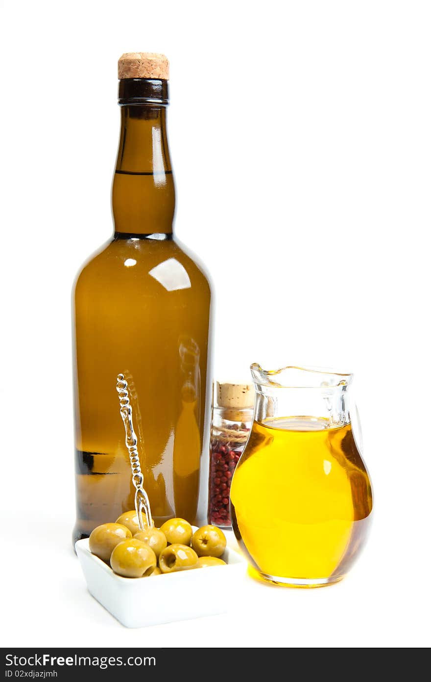 Appetizer of green olives and olive oil with bottle of wine