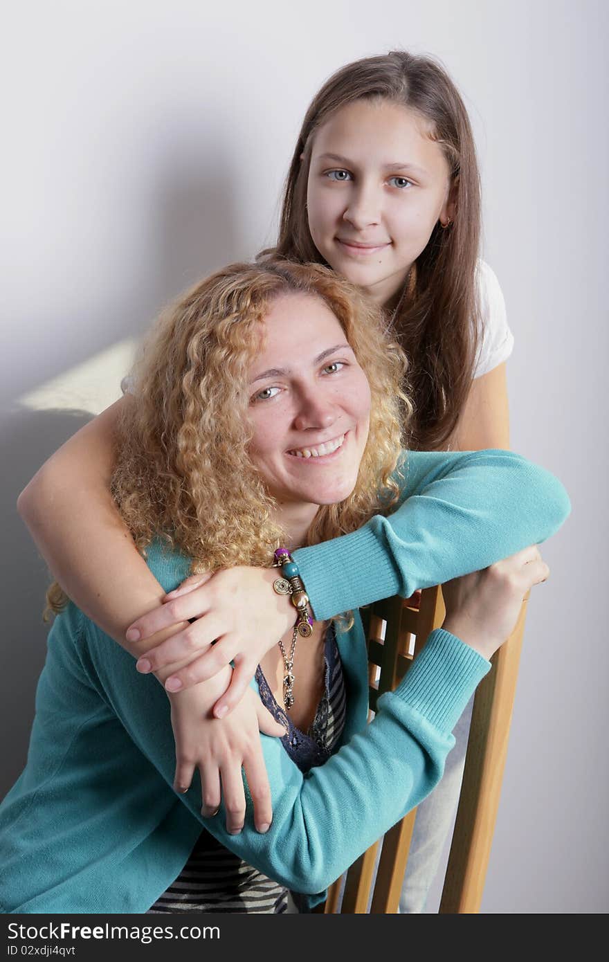 A portrait of mother and duaghter on a white background. A portrait of mother and duaghter on a white background