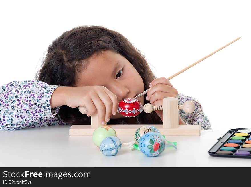 Paint easter egg, girl doing her creative hobby against white background