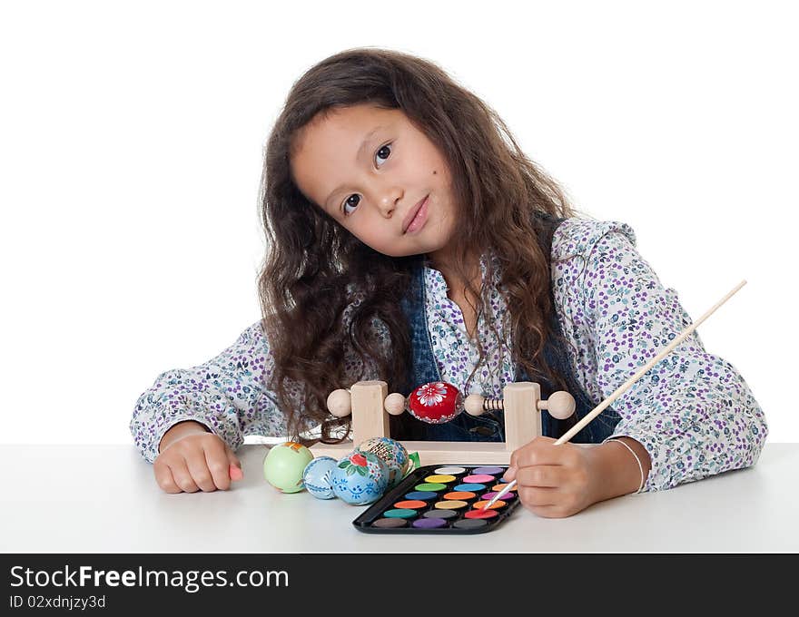 Paint easter egg, girl doing her creative hobby against white background