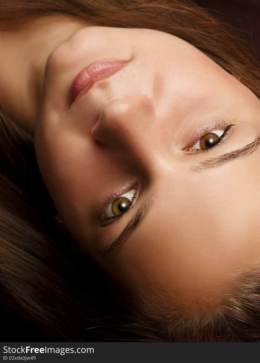 Portrait of a beautiful young girl upside down on a dark background. Portrait of a beautiful young girl upside down on a dark background.