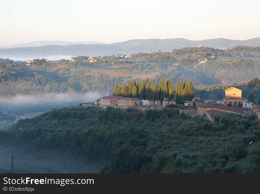 Fog burns off a hillside near Siena, in the Tuscany region of Italy. Fog burns off a hillside near Siena, in the Tuscany region of Italy