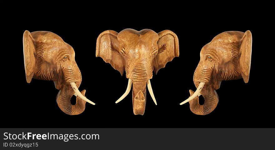 Sculpture (wood) picture elephant head. Isolated on pure black