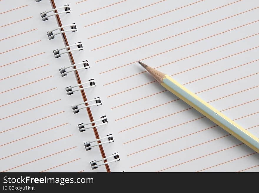 Blank notebook and pencil as white isolate background