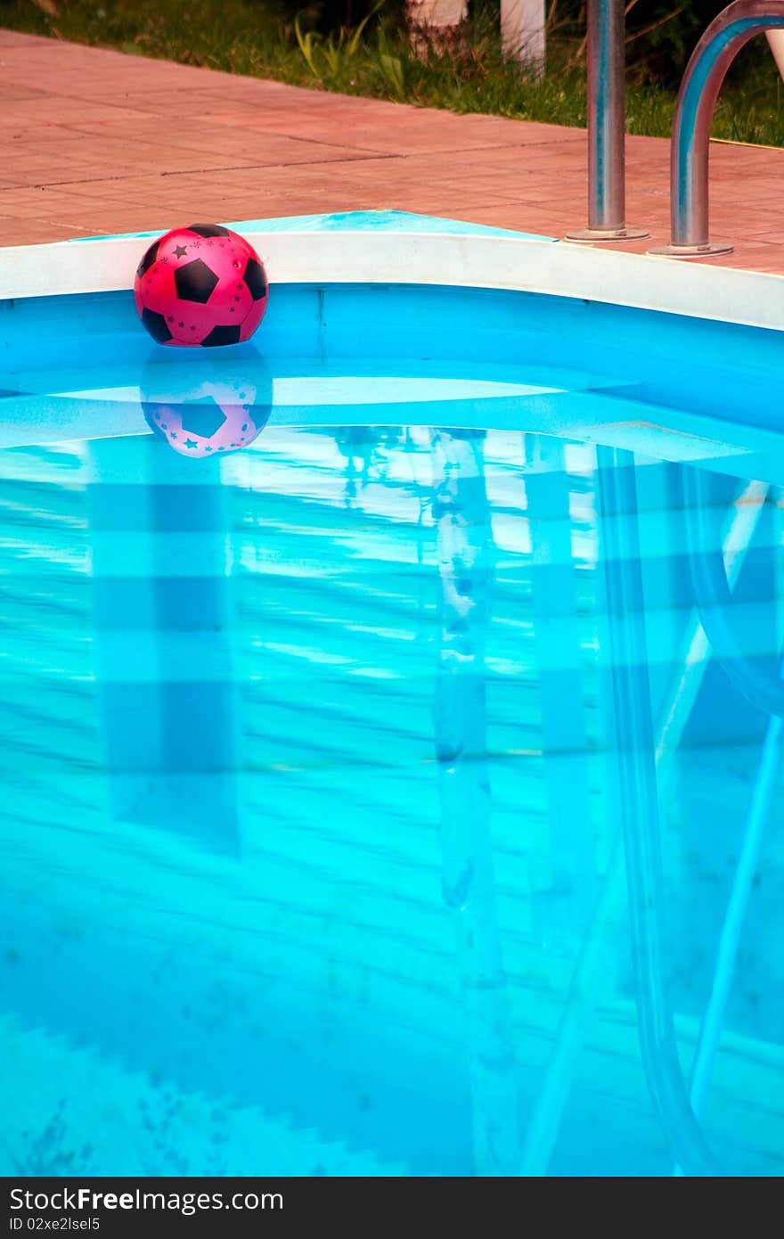 Ball is floating in pool near house