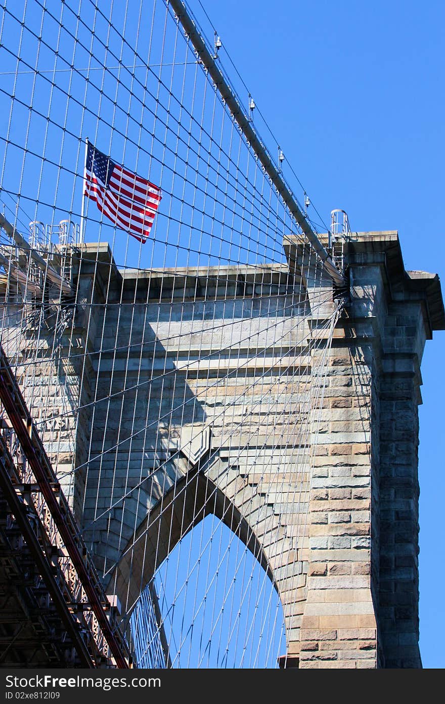 Looking up at the Brooklyn Bridge structure and suspension cables from the East River. Looking up at the Brooklyn Bridge structure and suspension cables from the East River