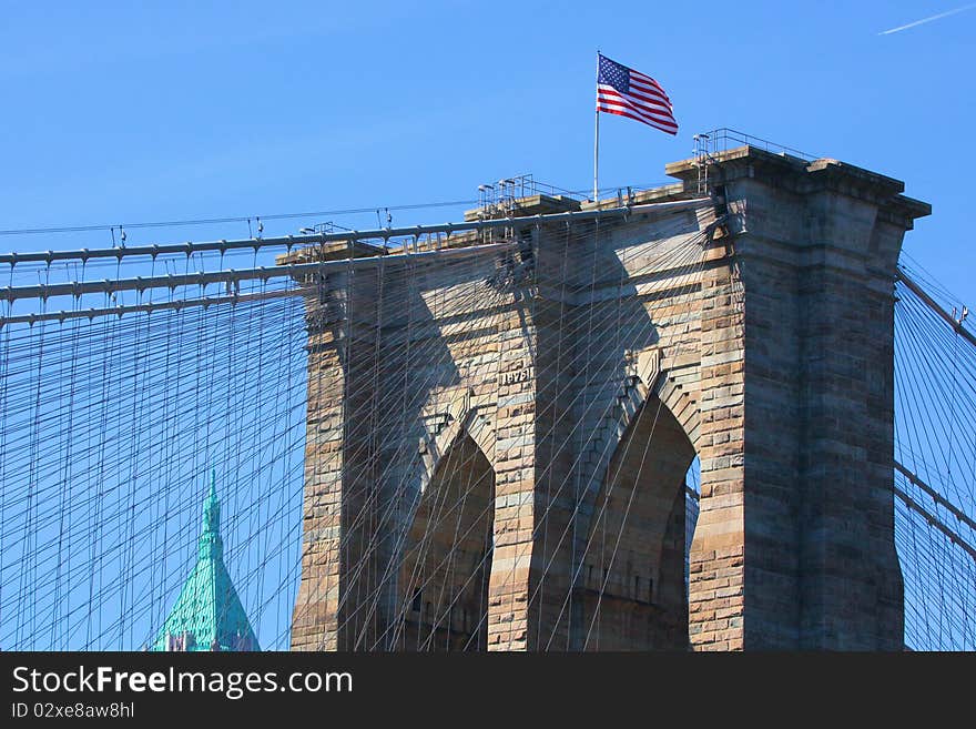 Looking up at the Brooklyn Bridge structure and suspension cables from the East River. Looking up at the Brooklyn Bridge structure and suspension cables from the East River