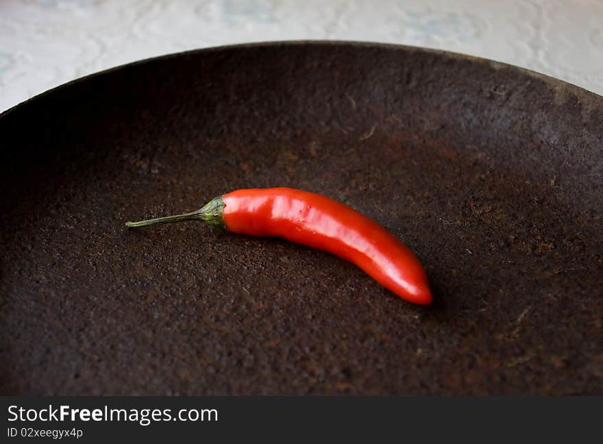 Red pepper on ferruginous surface