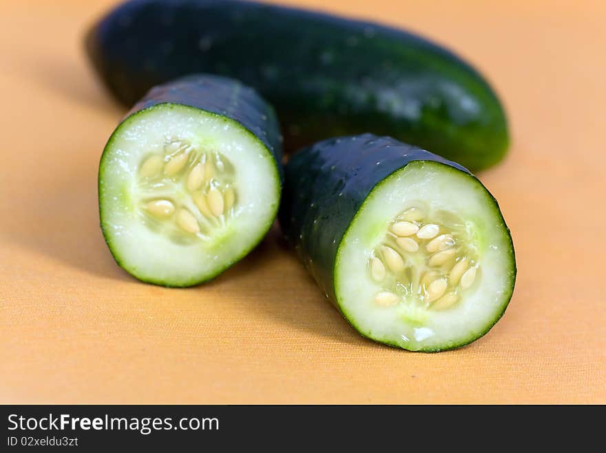 Ripe Cucumber on the orange Background.