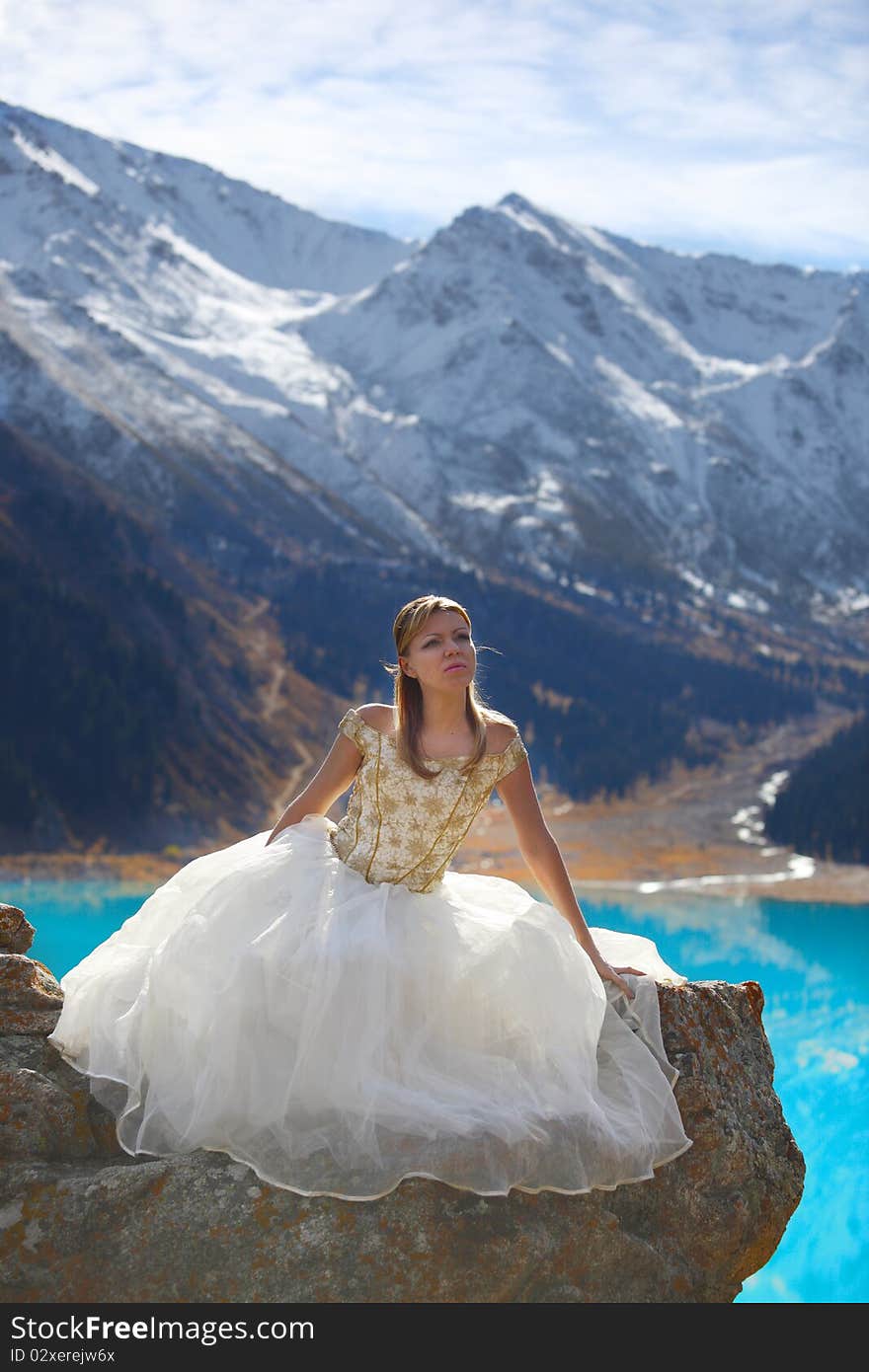 The girl in a dress in mountains