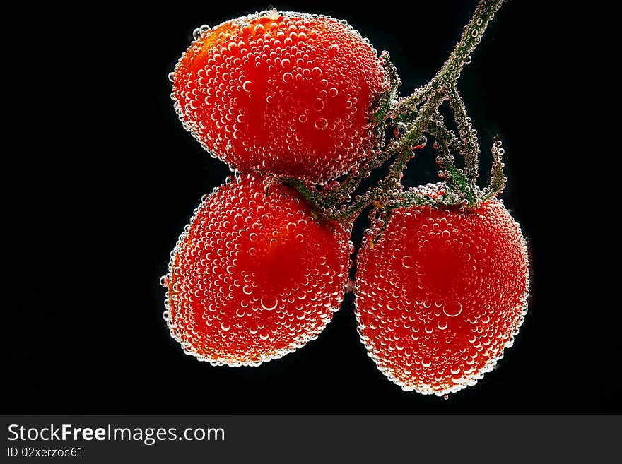 Three beautiful fresh tomato in water