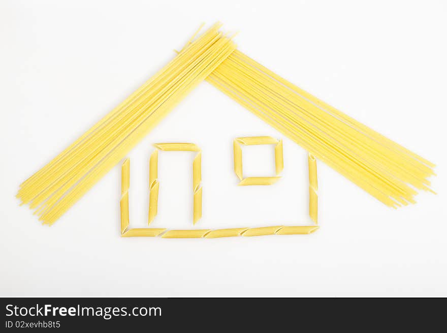 House built with a cylindrical and pasta noodles on a white background. House built with a cylindrical and pasta noodles on a white background