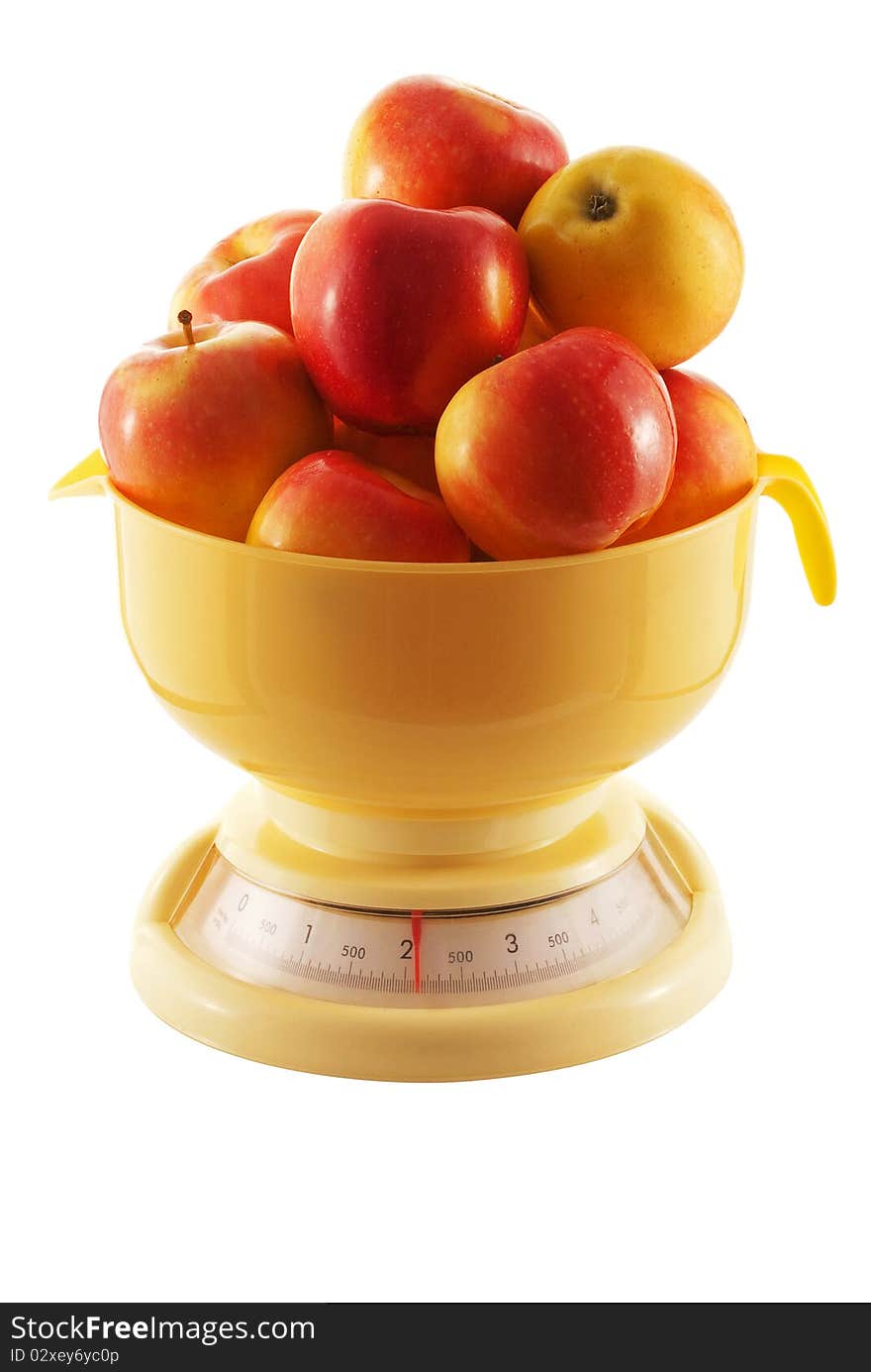 Ripe apples on the scales isolated on white background