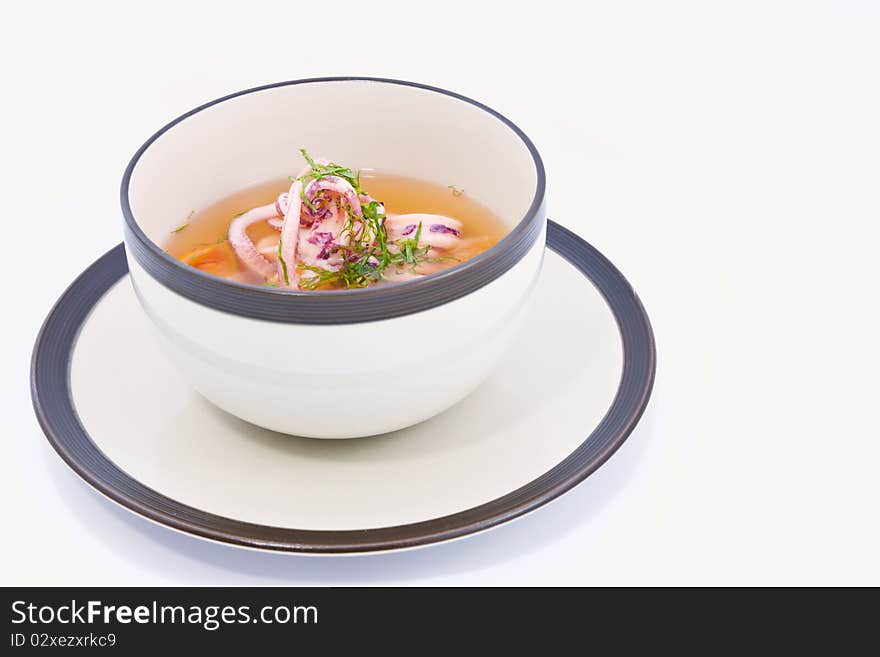 A flavorsome squid soup in white bowl